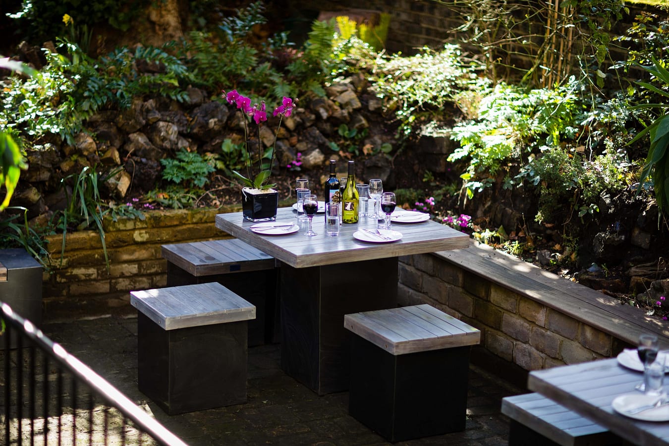 Photo of a garden with tables and chairs