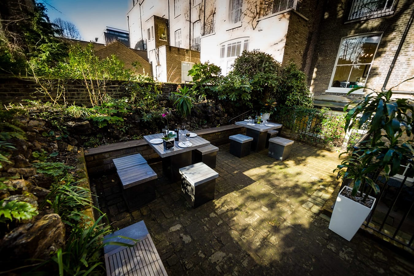 Photo of a garden with tables and chairs